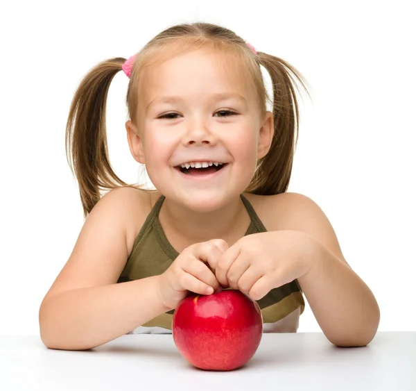 Portrait of a cute little girl with red apple — Stock Photo, Image