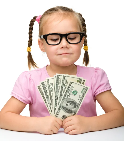 Cute cheerful little girl with paper money — Stock Photo, Image