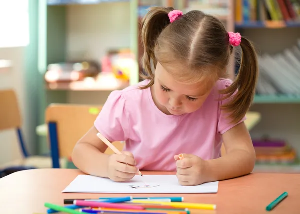 Cute little girl is drawing with felt-tip pen Royalty Free Stock Images