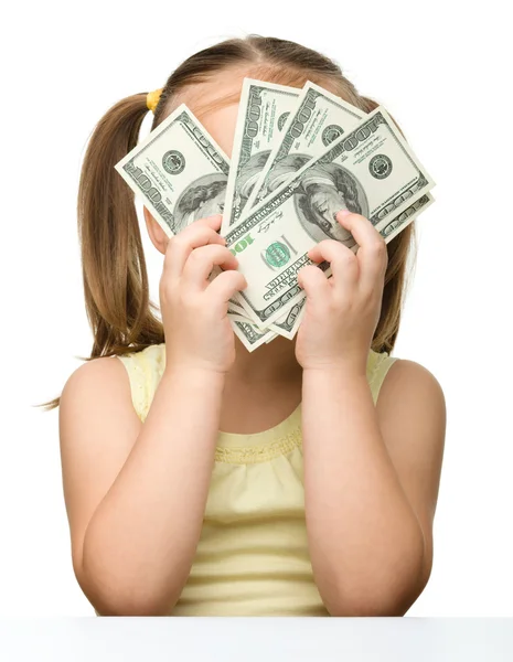 Niedliches kleines Mädchen mit Dollars — Stockfoto