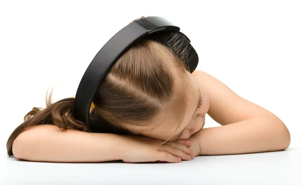 Cute little girl is sleeping in headphones — Stock Photo, Image