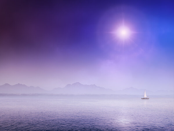 Sail Boat on misty ocean