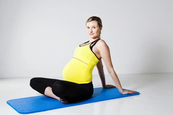 Gravid kvinna stretching och avkopplande — Stockfoto