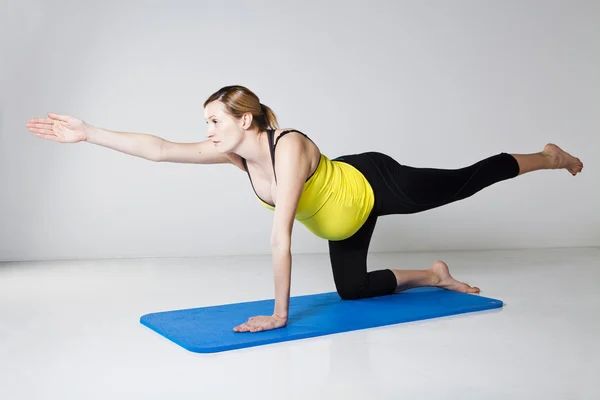 Stock image Pregnant woman exercising on mat