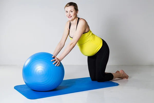 Беременная женщина с фитнес-мячом — стоковое фото