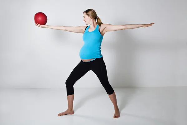 Pregnant woman exercising with exercise ball — Stock Photo, Image