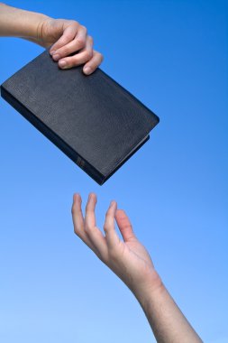 Hand Giving the Bible clipart