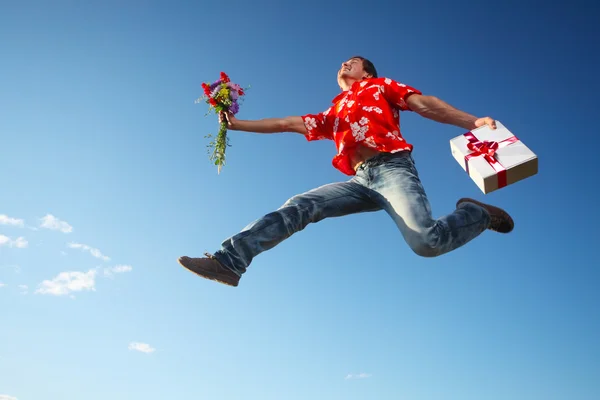 Man jumping with flowers — Stock Photo, Image