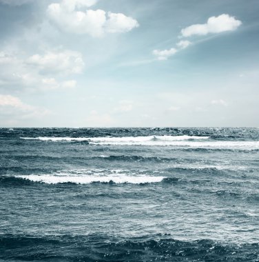 Waves on sea and sky with clouds clipart