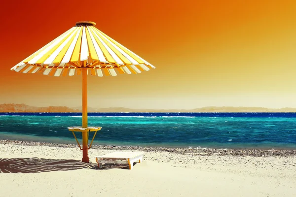 Hout paraplu op strand met duidelijk rood hemel — Stockfoto