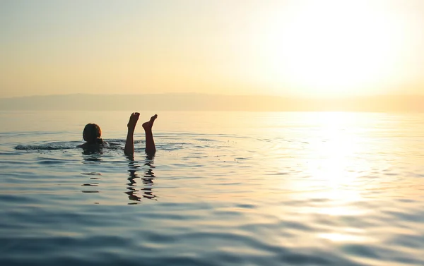 Woman swimming in salty water — Stok fotoğraf