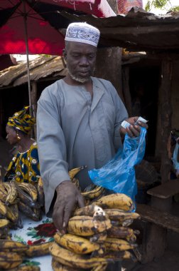 Shopkeeper selling plantain in Bamako clipart