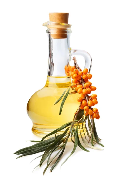 Bottle with oil and a branch with berries of sea buckthorn — Stock Photo, Image
