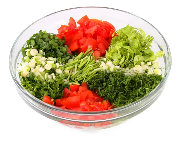 Salad vegetables and greens in a glass vase on a white backgroun — Stock Photo, Image