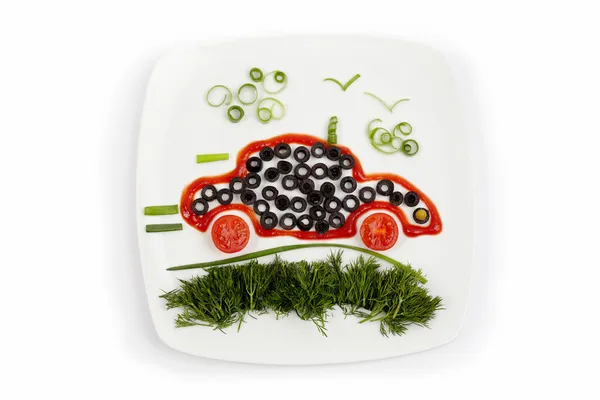 Concept of healthy eating - plate with vegetables as car goes on — Stock Photo, Image