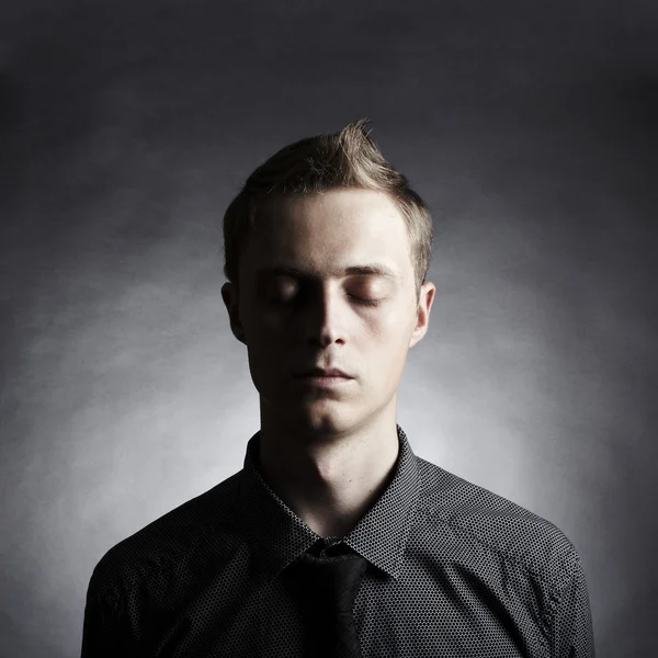 Portrait of a young stylish man against black background — Stock Photo, Image