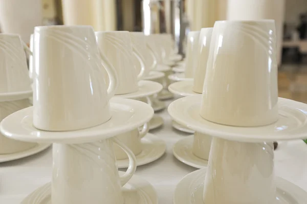 Closeup of cups and saucers in a row — Stock Photo, Image