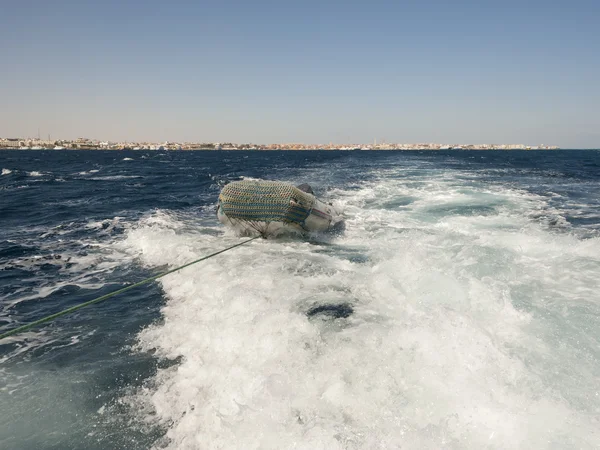 Pequeño bote inflable en barcos despertar —  Fotos de Stock