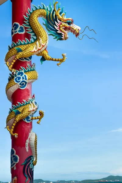 Dragão dourado envolto em torno de pólo vermelho — Fotografia de Stock