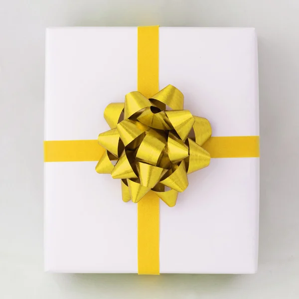 Estrela de ouro e fita de linha cruzada na caixa de papel branco — Fotografia de Stock