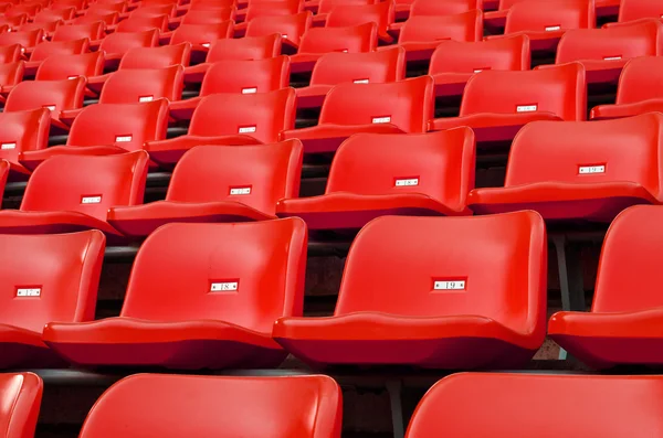 Red Empty plastic seats at stadium — Stock Photo, Image