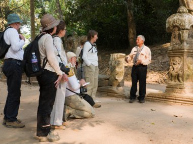 Unidentified guide explains the ancient art of stone carved clipart