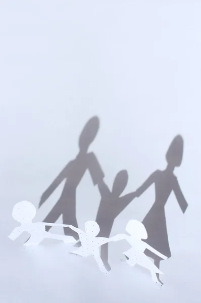 stock image Paper chain: man, woman and baby and shadows from them. F