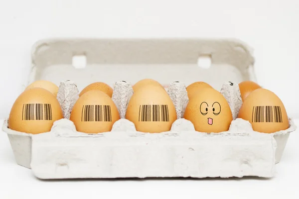 Eggs with same barcodes and one egg is different — Stock Photo, Image