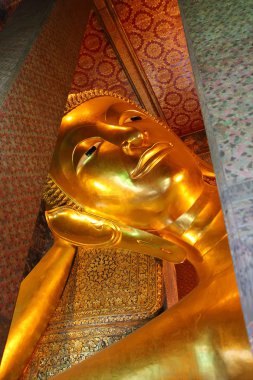 The reclining Buddha at Wat Pho in Bangkok, Thailand. clipart