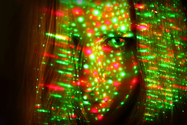 stock image Young girl's face with laser lightes
