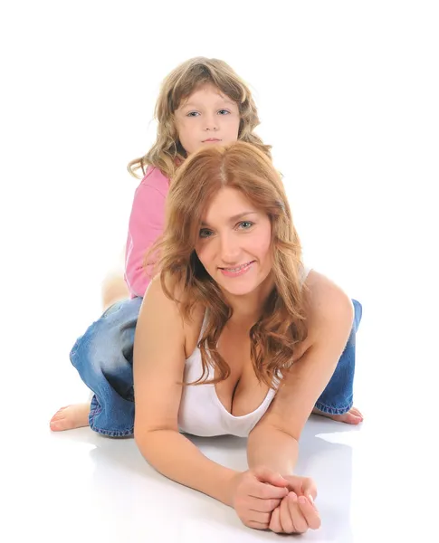 Cheerful girl hugs her young mother. — Stock Photo, Image