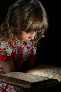 Teen girl reading the Book. clipart