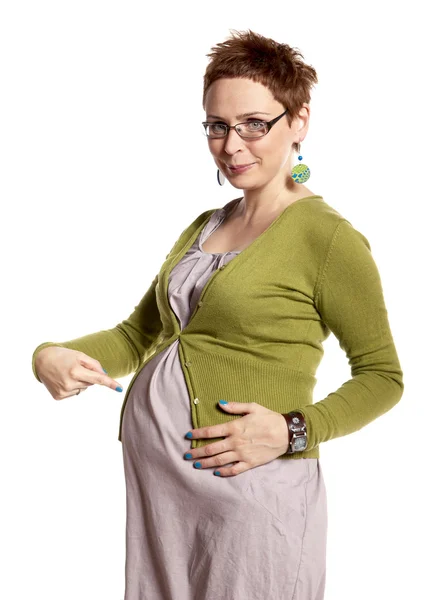 Těhotná žena ukazuje její břicho — Stock fotografie