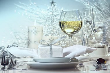 Festive dinner setting with gift for the holidays clipart