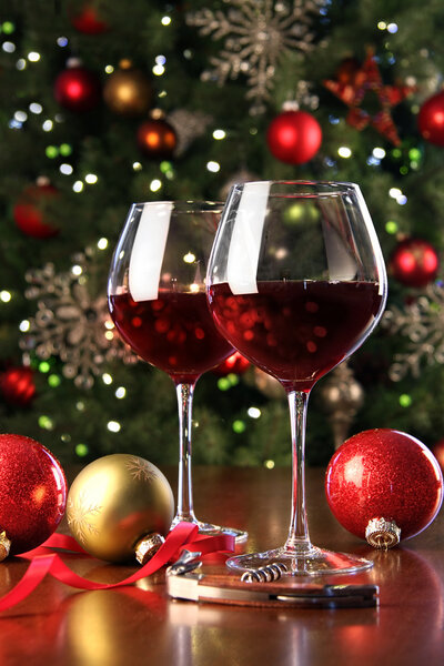 Glasses of red wine in front of Christmas tree