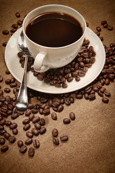 Filiżankę kawy na tle drewna — Zdjęcie stockowe