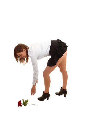 Girl picking up rose. clipart