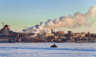 Snowmobile rides on the frozen river clipart