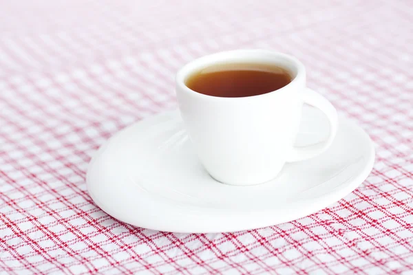 Kopje thee op geruite stof — Stockfoto