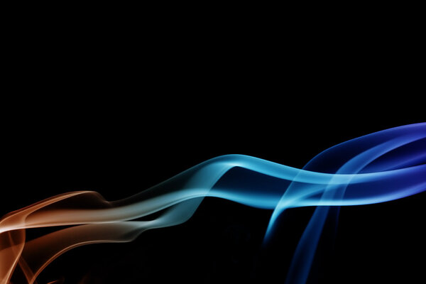 Wave and smoke of different colors on black background
