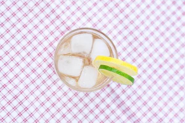 Вода с лимоном и лаймом в стакане со льдом — стоковое фото