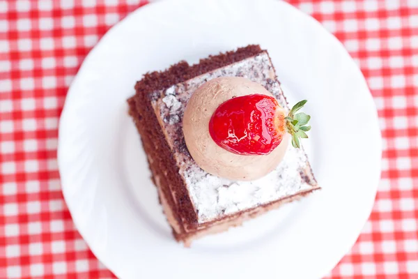 Prachtige cake met aardbei op geruite stof — Stockfoto