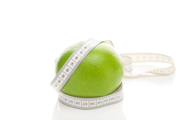 stock image Green grapefruit and measure tape isolated on white