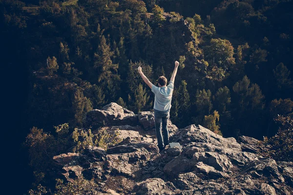 Молодий чоловік стоїть на схилі скелі — стокове фото