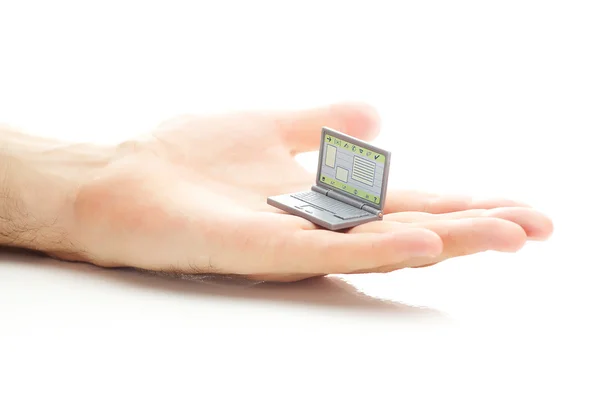 Laptop em miniatura na mão isolado no branco — Fotografia de Stock