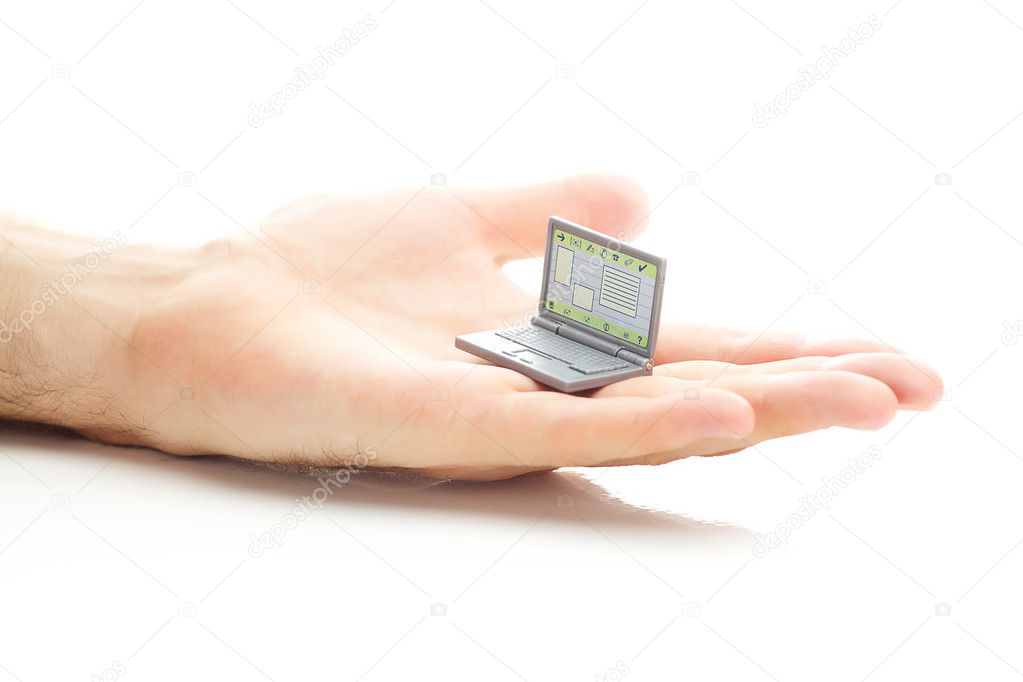 Miniature laptop in hand isolated on white