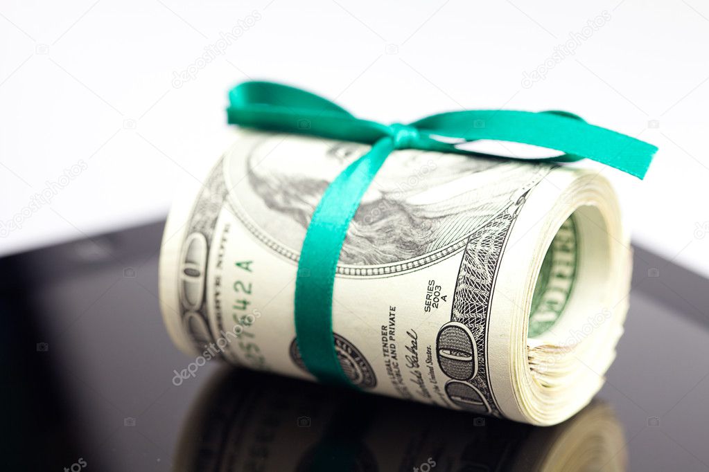 Tablet and tube of dollars isolated on white