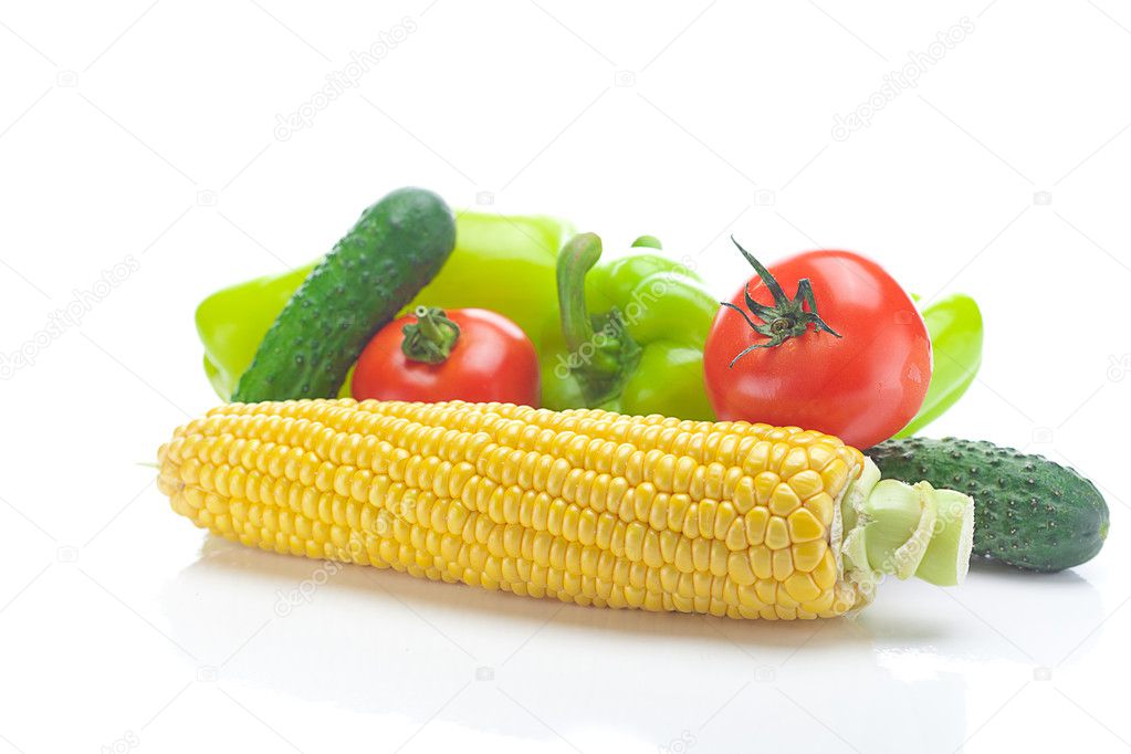 Tomatoes, peppers, cucumbers and corn isolated on white