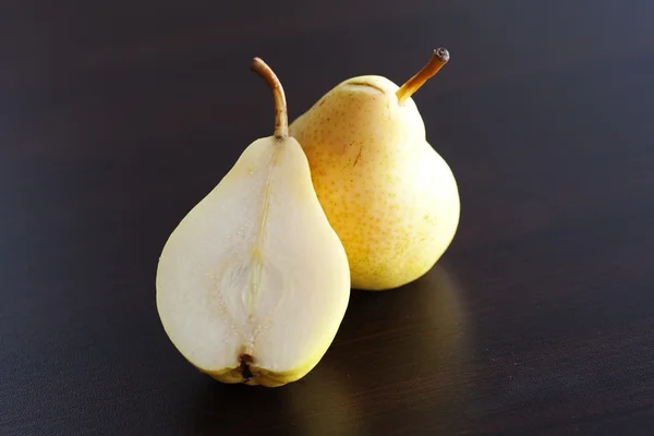 Pear lying on a wooden table — Stock Photo, Image