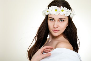 Beautiful smiling woman in chamomile wreath